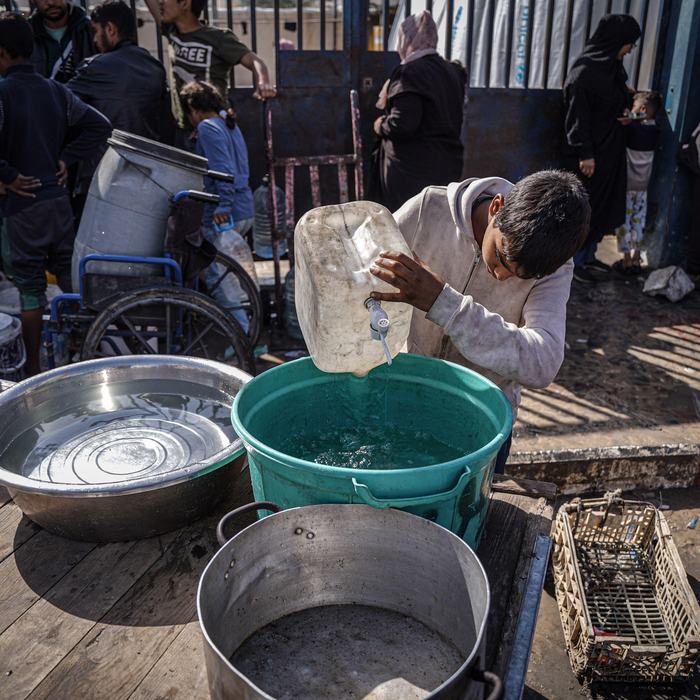 Palestinians collect water from a water filling station where people suffer from water shortages due to the war, Rafah, Gaza.