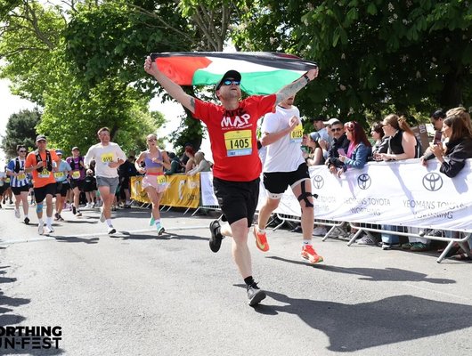 Runner holding Palestinian flag