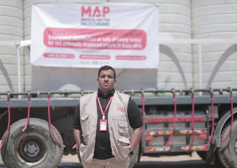 Water Agent standing in front of truck