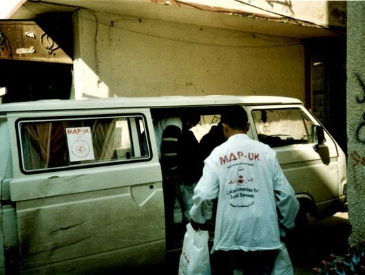 MAP Volunteer loading food parcels onto a van