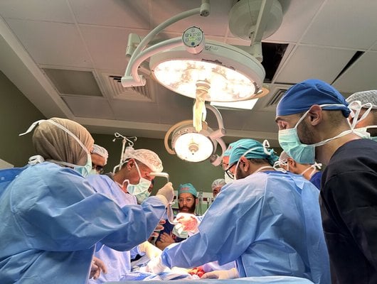 A team of medics operating in the operating theatre of Al-Aqsa Hospital, Deir al-Balah