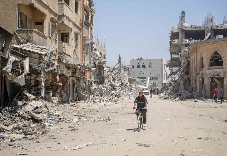 Man on a bike cycling through Gaza