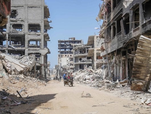 Palestinians collecting food at a distribution point in Gaza