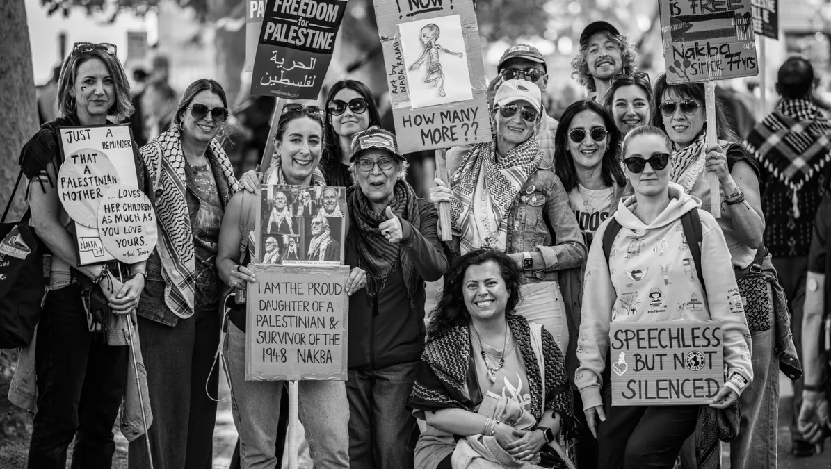 A black and white group shot of the March for Palestine Solidarity Sisters at a London protest.