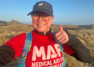 Rachael wearing a red Medical Aid for Palestinians t-shirt