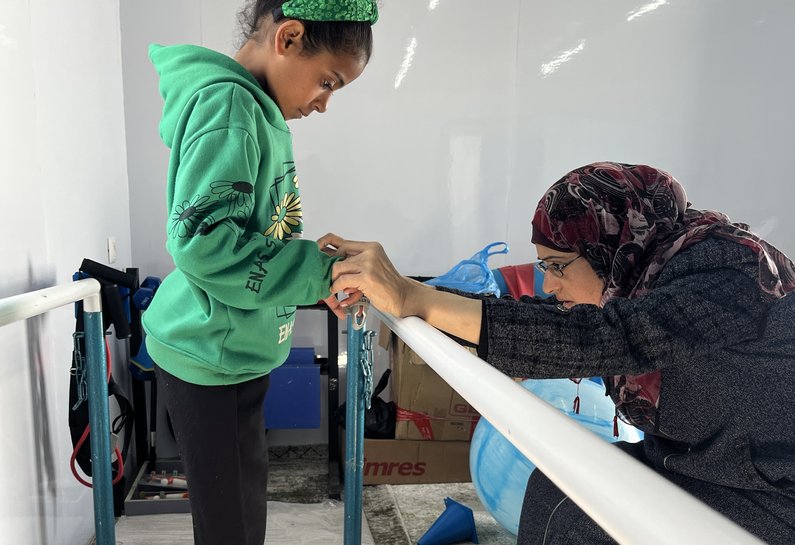 Dr Nahla Musallam, a physiotherapist, cares for a child at MAP’s Solidarity Polyclinic.